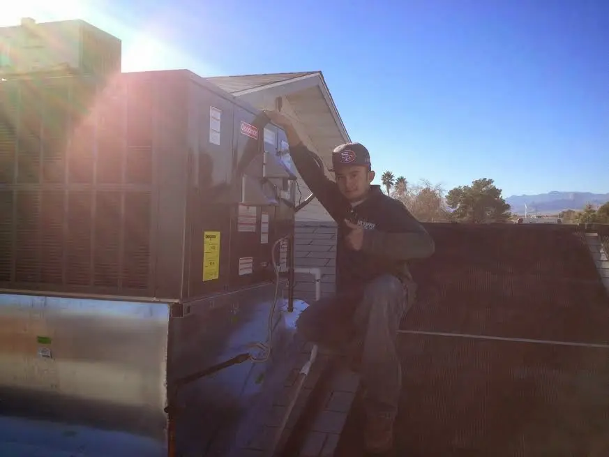 HVAC technician performing Heat Pump Repair on a rooftop unit in Lakeway